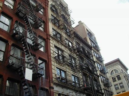 Fire stairs on the sides of tenement buildings<br>Location: <a href="https://www.google.com/maps/search/?api=1&query=40.72437,-74.00151" target="_new">New York City Tour, Spring St between West Broadway and Wooster St</a>